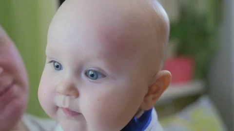 Portrait of a chubby eight-month-old baby. Close up shot. Stock Footage 126692379