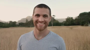 Portrait of clean cut young man smiling outdoors Stock Footage 85654667