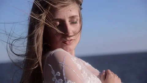 Portrait. close up. attractive long-haired girl standing alone by the sea in whi Stock Footage 129276746