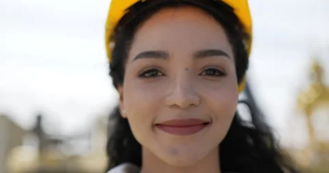 Portrait close up face of beautiful engineer woman curly hair wearing helmet Video stock 227089309