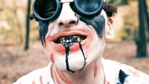 Portrait is close-up of face of zombie with traces of blood and black fluid 스톡 동영상 211323568