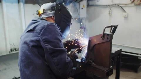 Portrait close-up of a professional blacksmith or welder in uniform, protective Video stock 224882769