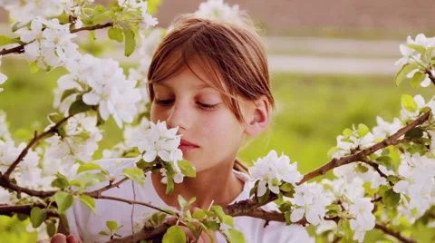 Portrait close-up, white-skinned boy in the spring garden. Stock Footage 49957966