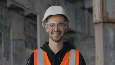 Portrait, close-up of a worker in a white helmet looking at the camera. Video stock 132891006
