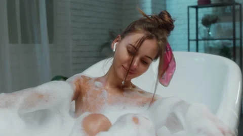 Portrait closeup to the camera cute lady take a bath with bubble ad feeling Stock Footage 158239551