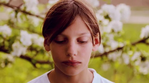 Portrait closeup, white-skinned boy in the spring garden. Video stock 49958694