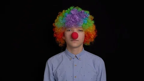 Portrait of a clown on a black background Stock Footage 126238049