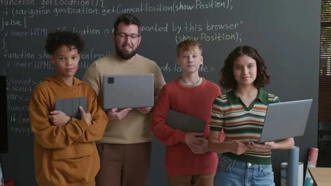 Portrait of Coding Teacher and Students with Gadgets in front of Blackboard Stock Footage 318720890