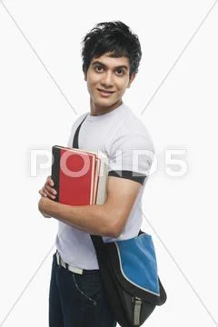 Portrait of a college student holding notebooks Stock Photos