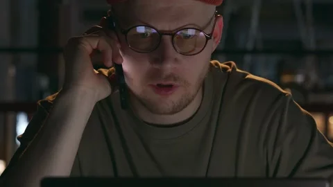A portrait of a computer programmer who is very nervous talking on the phone Stock Footage 262305716
