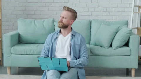 Portrait of a concentrated beaded man, thinking and typing, with his laptop. Stock Footage 155811046