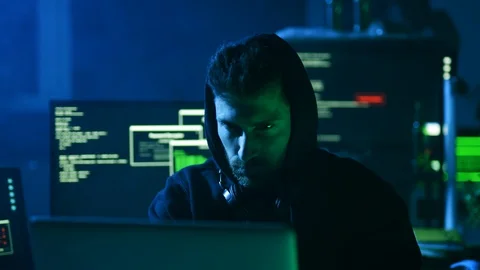 Portrait of concentrated dangerous hacker coding virus ransomware on laptop and Stock Footage 108822567