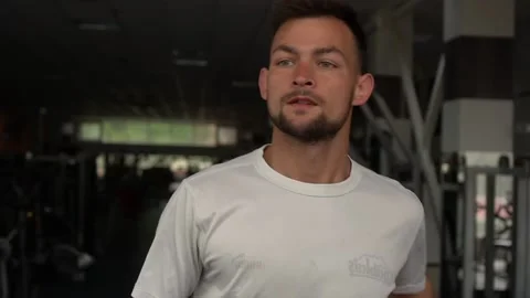 Portrait of concentrated man practicing on run machine in gym. Close up Stock Footage 132173259