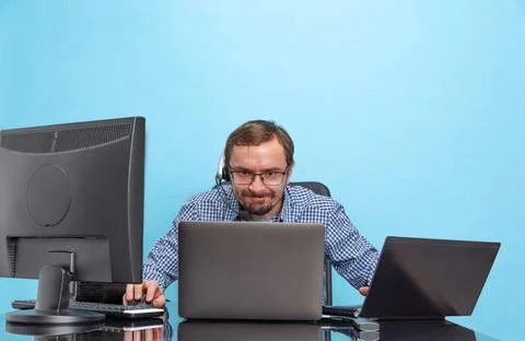 Portrait of concentrated man, programmer, computer system analyst working with Stock Photos