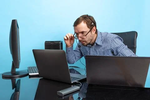 Portrait of concentrated man, programmer, computer system analyst working with Stock Photos