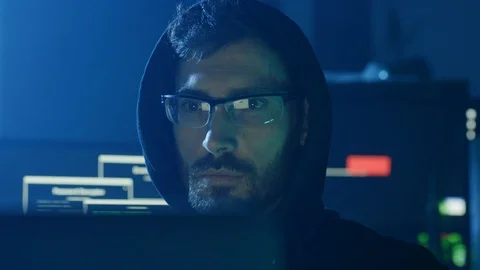 Portrait of concentrated programmer looking at computer interface sitting at Видео 108823364