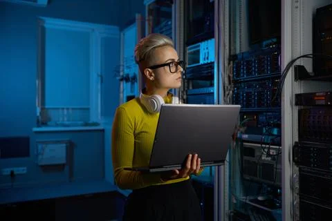 Portrait of concentrated woman coder solving problem in data center Stock Photos