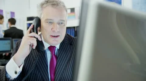 Portrait of a confident and mature stock market trader at work in a busy office Stock Footage
