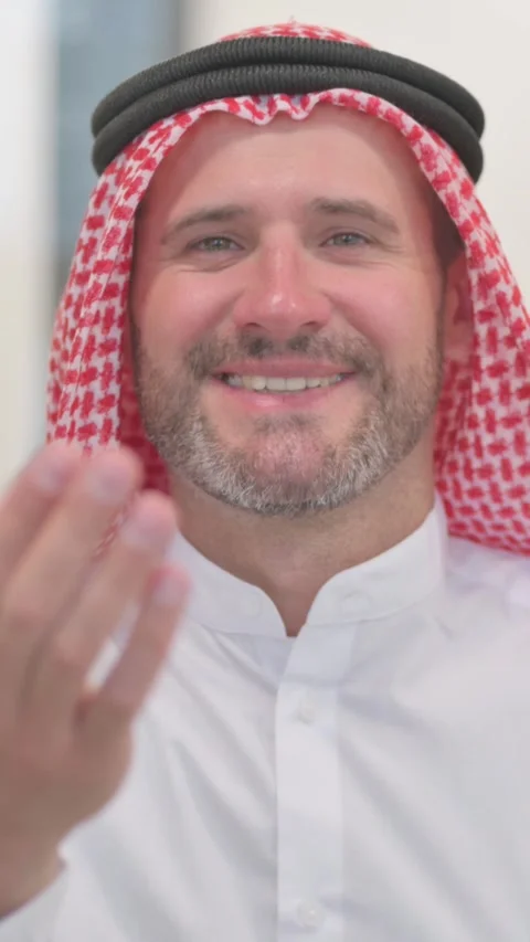 Portrait of Confident Arab Man inviting People, vertical video Stock Footage 324709347
