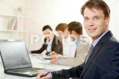 Portrait of confident boss looking at camera on the background of working people Stock Photos