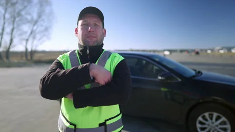 Portrait of confident Caucasian auto instructor crossing hands and looking at Video stock 148742810