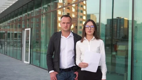Portrait of confident company workers in suits outside office building. Stock Footage