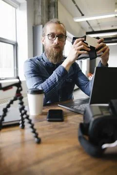 Portrait confident computer programmer with virtual reality simulator glasses in 스톡 사진