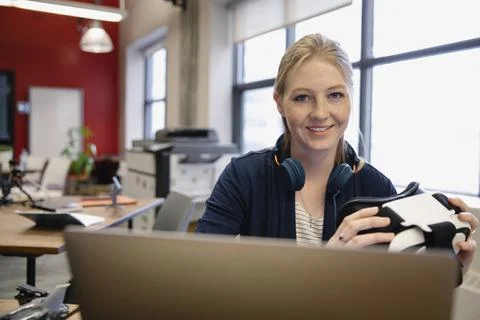 Portrait confident computer programmer with virtual reality simulator glasses wo Stock Photos