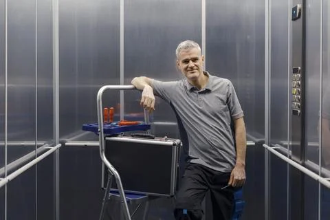 Portrait of a confident elevator mechanic at work Stock Photos