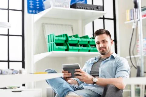 Portrait of confident engineer using tablet computer while sitting in 스톡 사진