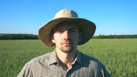 Portrait of confident farmer in hat looking into the camera Stock Footage 104048517