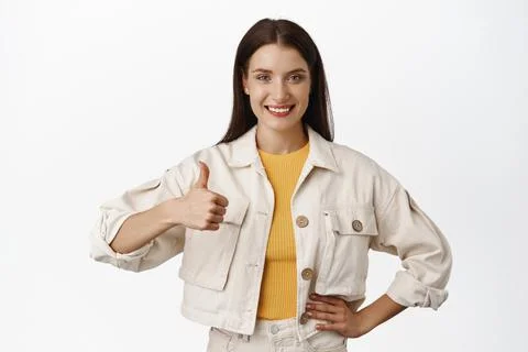 Portrait of confident girl show thumb up and nod in approval, say yes, praise Stock Photos