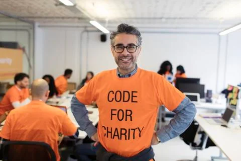 Portrait confident hacker coding for charity at hackathon 写真素材