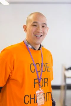 Portrait confident hacker coding for charity at hackathon Stock Photos