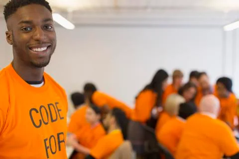 Portrait confident hacker coding for charity at hackathon Stock Photos