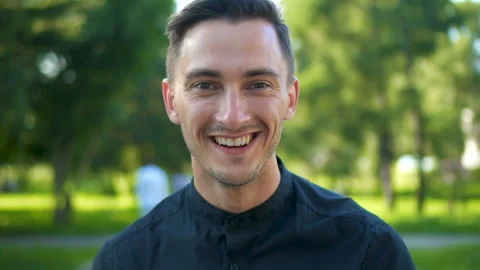Portrait of confident handsome young guy smiling enjoying successful urban Stock Footage 95925613