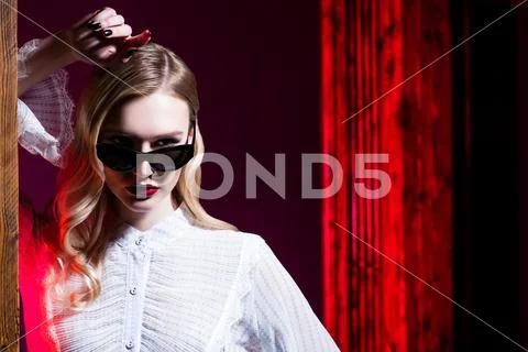 A portrait of a confident lady wearing glasses. Beauty, make-up, style. Stock Photos