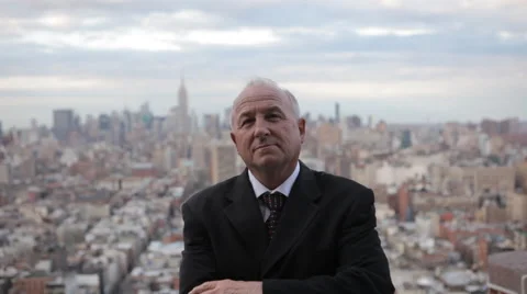 Portrait of confident mature business man looking over the Manhattan at twilight Stock Footage