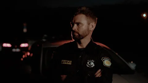 Portrait of confident professional cop smiling with arms crossed standing Video stock 112990701