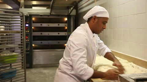 Portrait of confident professional Hispanic baker working with raw yeasted dough Stock-Footage 157428532