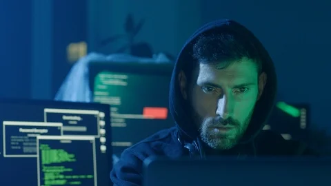 Portrait of confident programmer or internet hacker in hoodie looking at Stock Footage 108823542