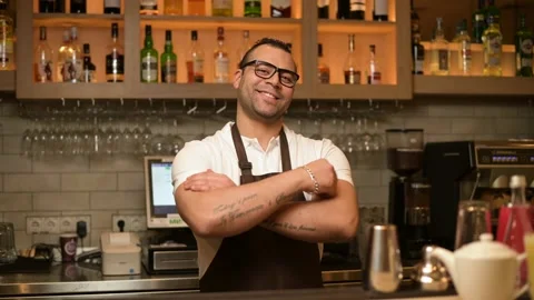 Portrait of a confident smiling bartender at the bar in a restaurant Video stock 148898426