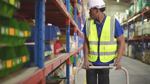 Portrait of a confident warehouse worker use the cart to select products Stock Footage 254402822