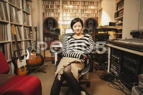 Portrait of confident woman sitting in music studio Stock Photos