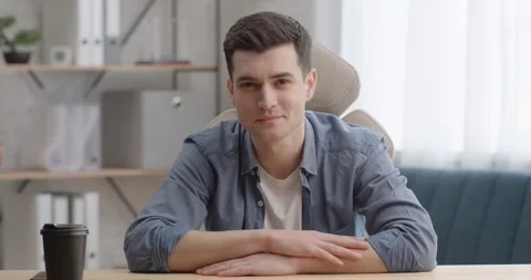 Portrait of Confident Young Man Manager sitting at comfortable Office Room Stock Footage 150558010