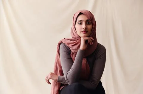 Portrait of confident young Middle Eastern woman wearing hajib looking at cam Stock Photos