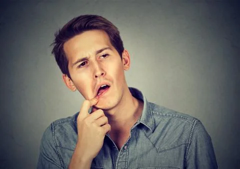 Portrait of a confused perplexed man Stock Photos