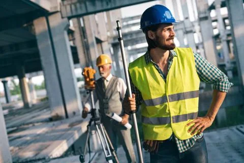 Portrait of construction architects, engineers working on building site Fotos de archivo