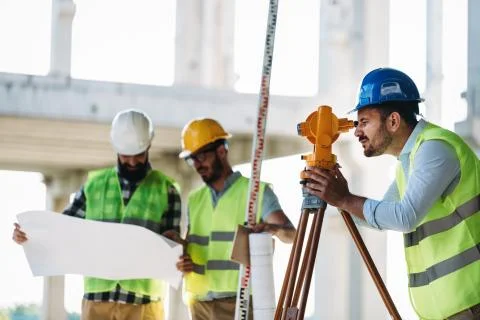 Portrait of construction engineers working on building site Stock Photos