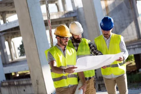 Portrait of construction engineers working on building site Stock Photos